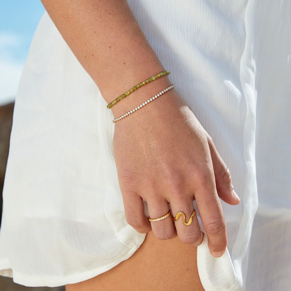 Kordelie guld tennisarmband