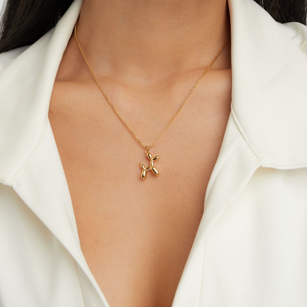 Nora – Glittrande halsband med hängande fjäril.