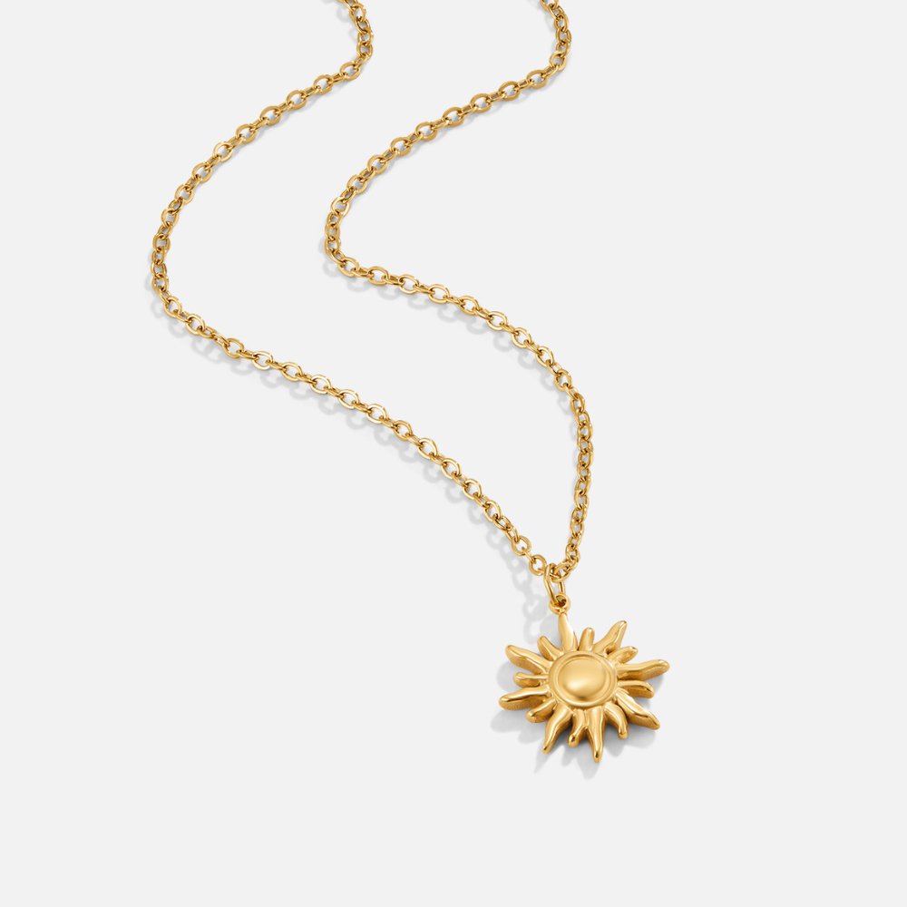 Ronja – Guldhalsband med blomma.